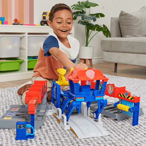 An image of a child playing with the Highway Rescue HQ Playset
